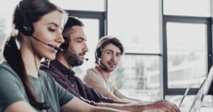 Telefonos kérdezők fejhallgatóval egy irodában – AI telefonos lekérdezés közvélemény-kutató cégeknek